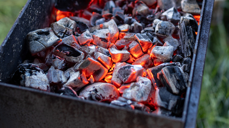 Charcoal burning outside in an uncovered grill