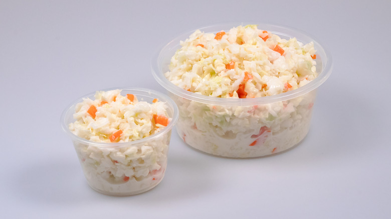 Two containers filled with coleslaw.