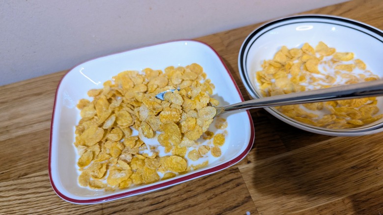 spoon scooping cereal in milk