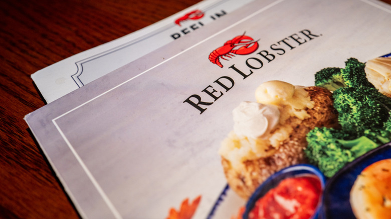 The Red Lobster menu on a wooden table.