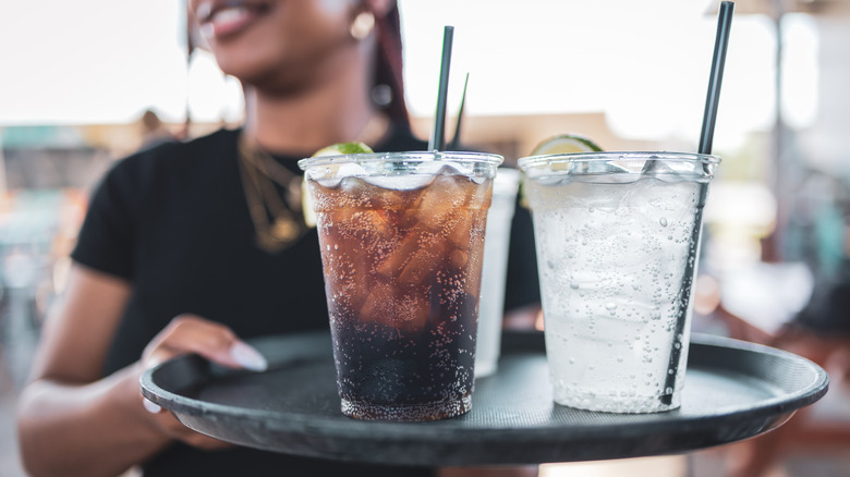 Serving drinks on a black tray