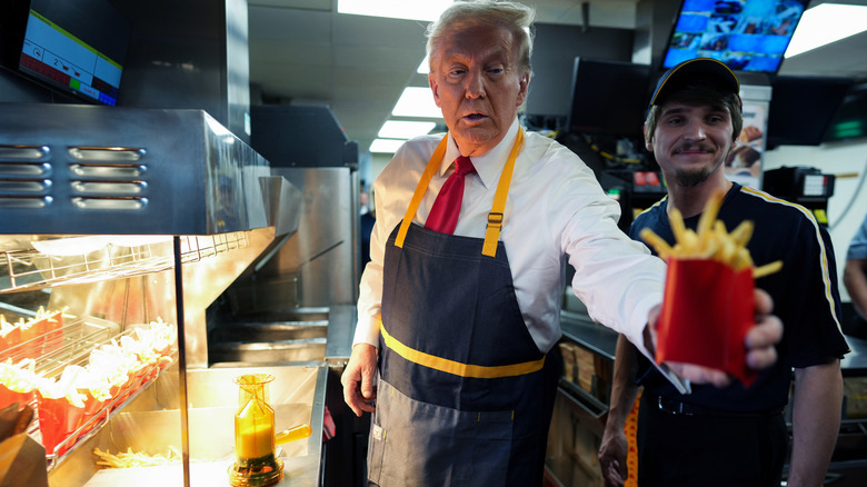 Donald Trump handing out French fries in a McDonald's kitchen