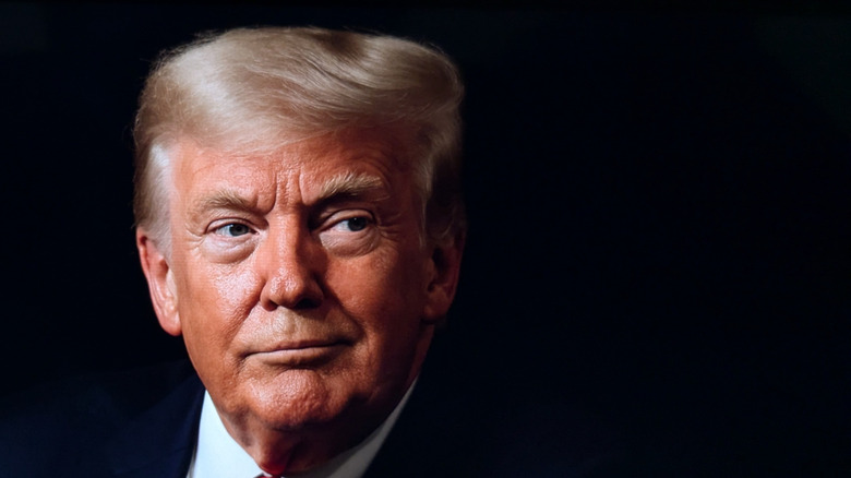 Donald Trump against a dark background