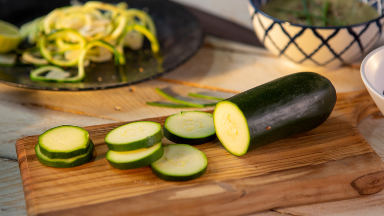 Sliced zucchini on a wood cutting board