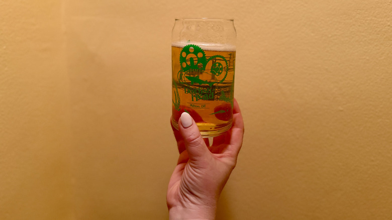 Dogfish Head Grateful Dead Citrus Daydream Lager held by hand in a glass