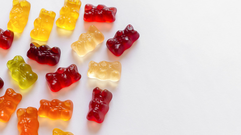 Colorful Haribo gummy bears on white background.