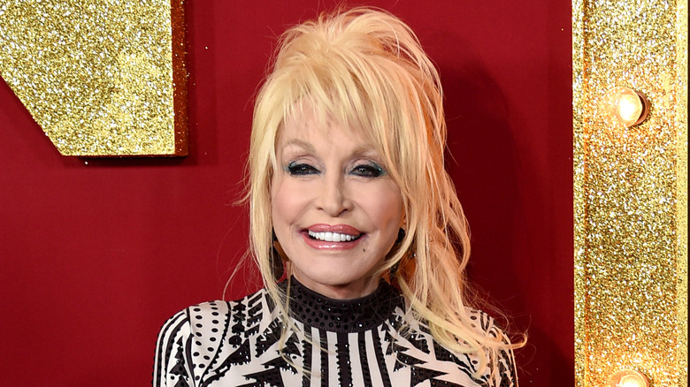 Dolly Parton smiling at red carpet event.