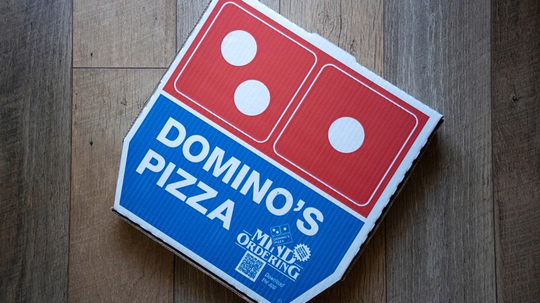 Domino's pizza box on a wood background
