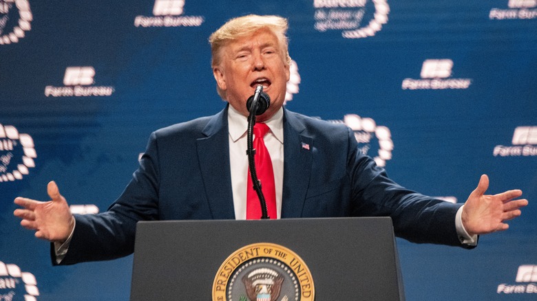 Donald Trump speaking behind a podium