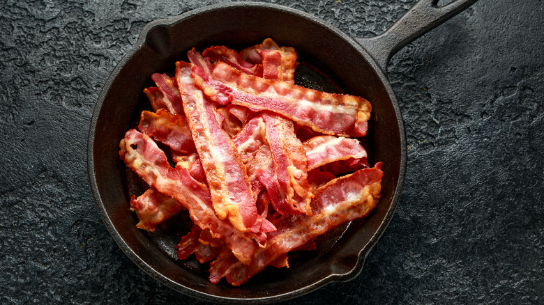 Pieces of bacon in cast iron pan