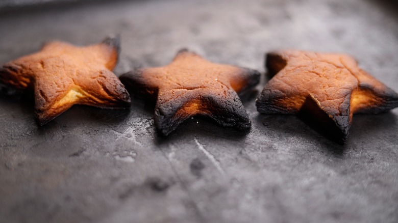 Burnt cookies on a black pan