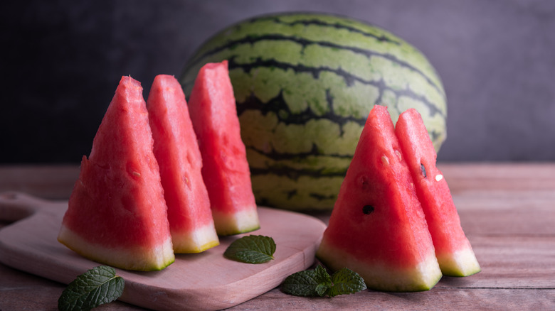 watermelon cut into wedges on a cutting board