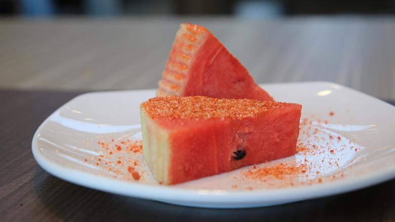watermelon wedges sprinkled with seasoning on a plate