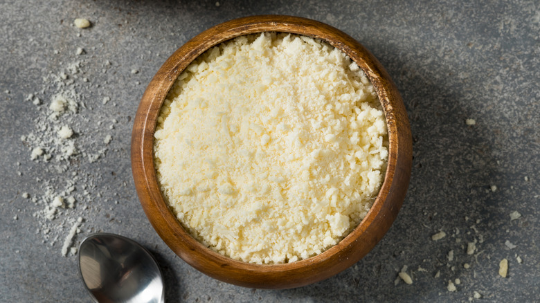 Small wooden bowl of grated parmesan cheese