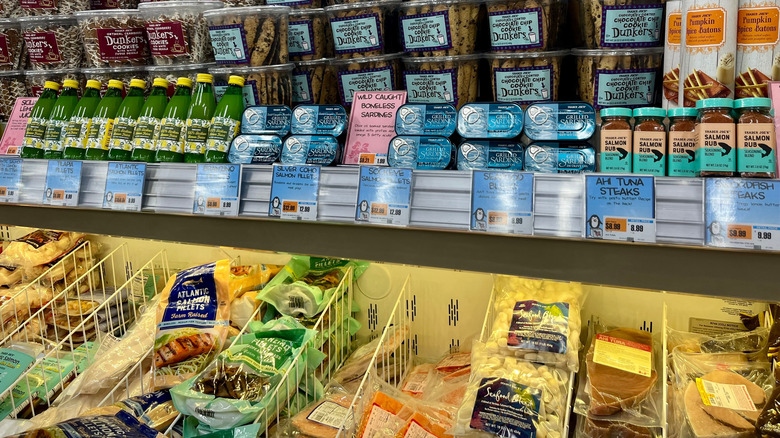 Frozen foods and sweets stacked above them in a Trader Joe's