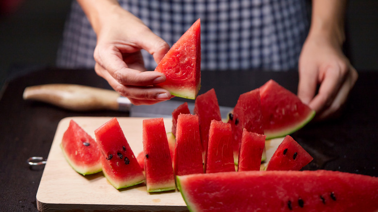 a home cook cuts a watermelon into wedges