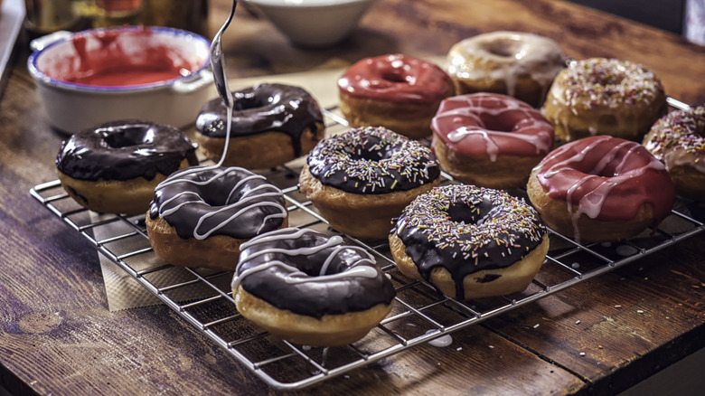 Donuts on cooling rack, decorated with different glazes and toppings