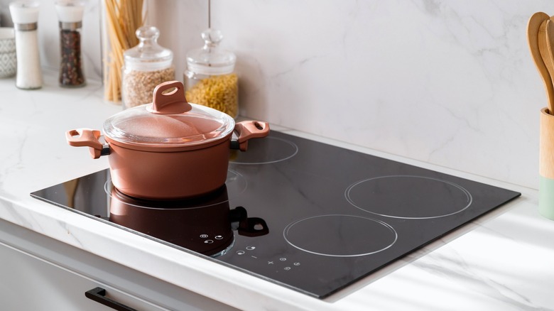 Electric stovetop with a pot on burner