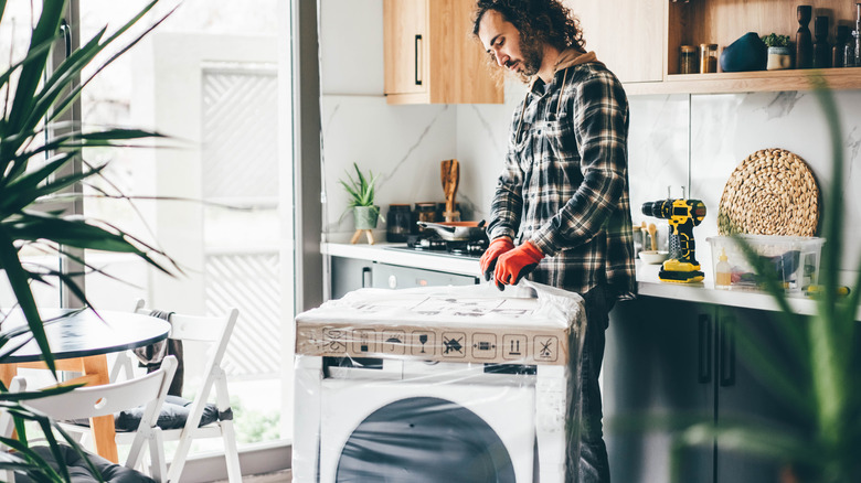 A homeowner inspects a new kitchen appliance