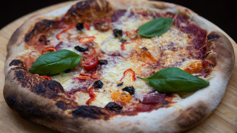 pizza with sourdough crust on a wooden plate