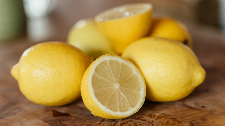 whole and cut lemons on a countertop