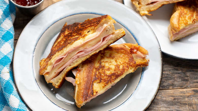 Halved Monte Cristo sandwich on white plate