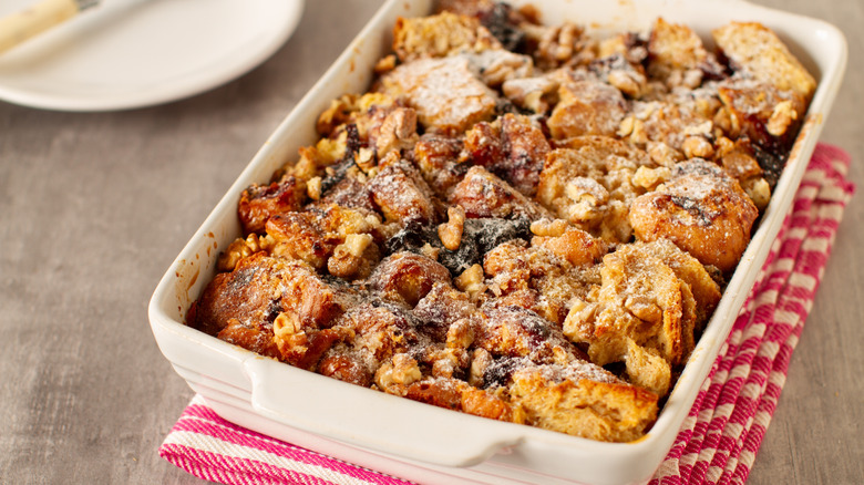 Baking dish of bread pudding with dried fruits and nuts