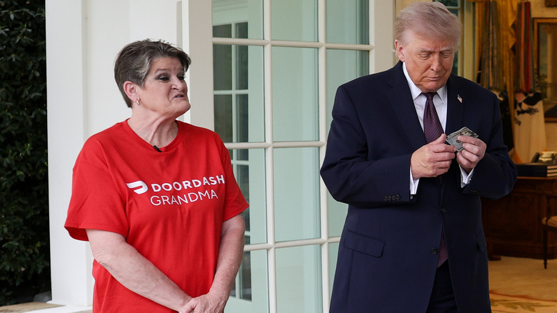 Sharon Simmons speaking beside President Donald Trump as he holds a bill in his hand and smiles outside the White House