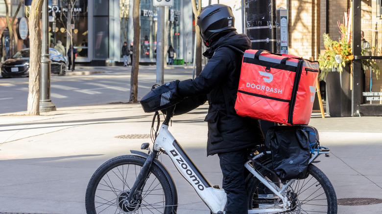 DoorDash delivery person on a rental ebike