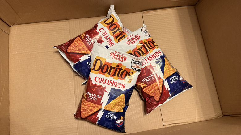 a box containing bags of Doritos x Stranger Things Pizza Cool Ranch Collisions