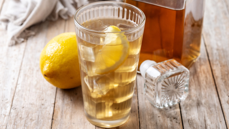 Whiskey soda in highball glass with lemon wedge