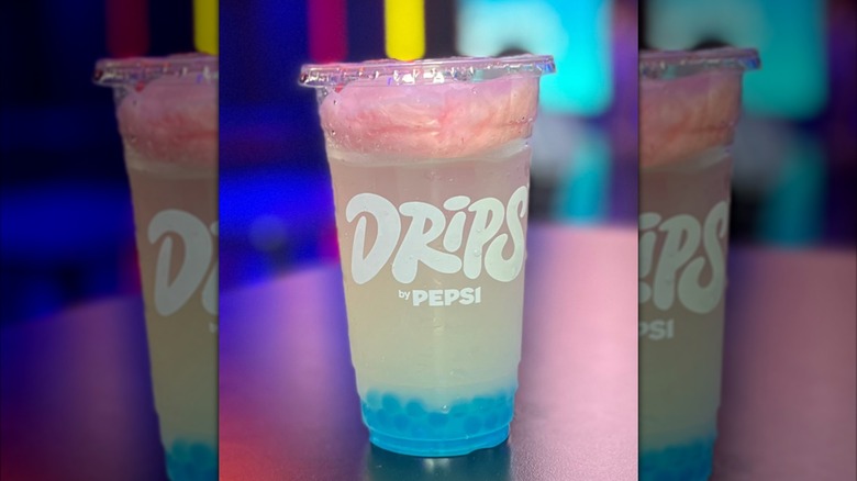 A tall plastic cup of Tropicana Cotton Candy Lemonade