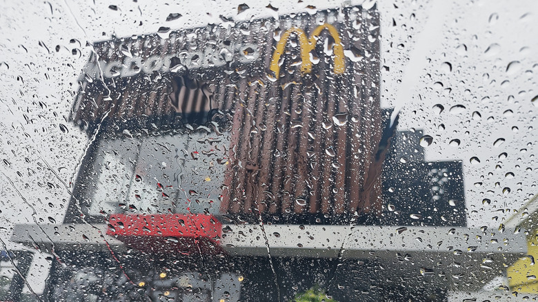 A McDonald's location seen through a wet car window