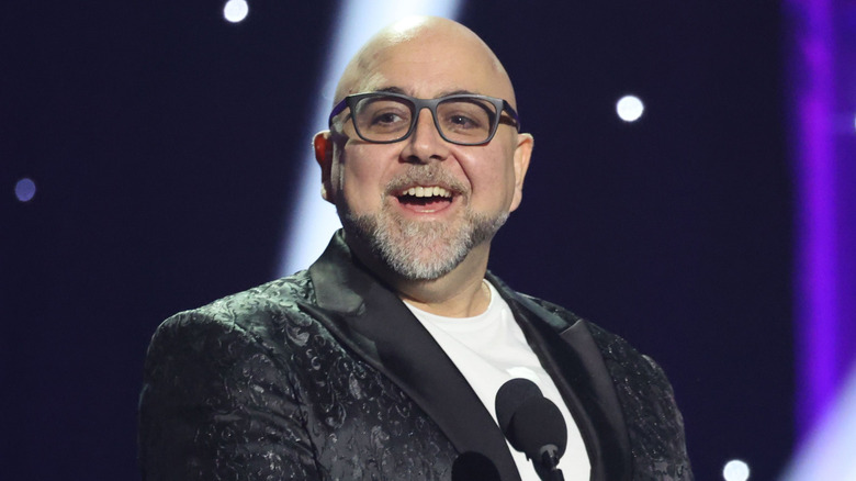 Duff Goldman wearing glasses with a black suit jacket