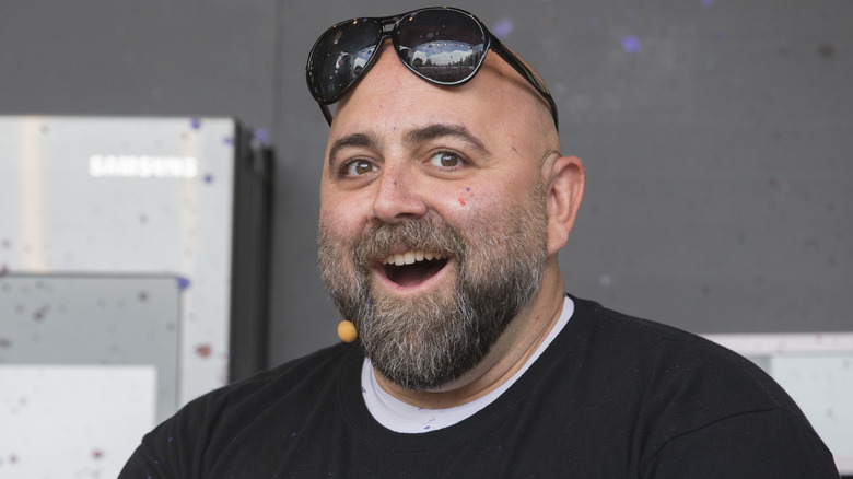 Duff Goldman wears sunglasses on his forehead at an event