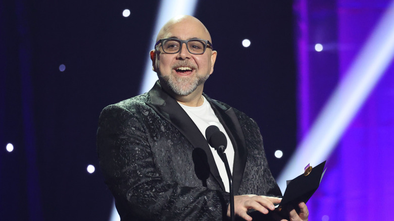 Duff Goldman in glasses smiling in front of microphone