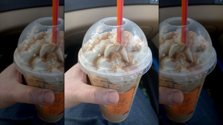 Hand holding Caramel Craze Signature Latte