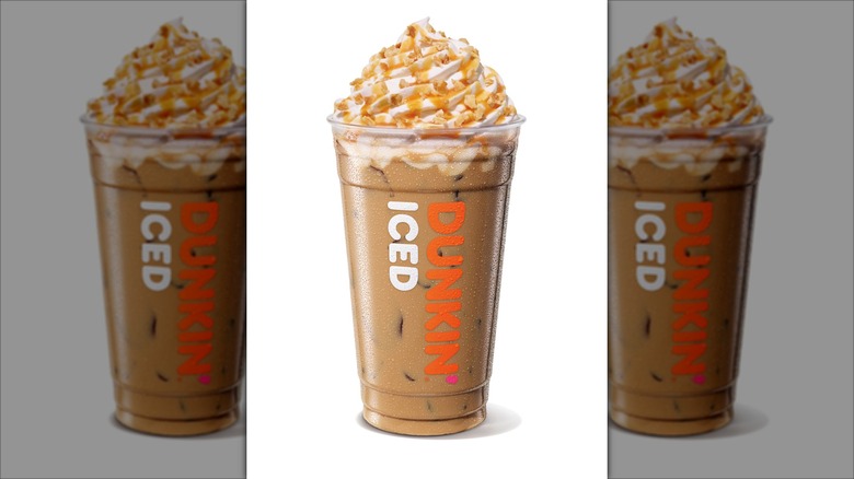 Dunkin's new iced pistachio latte with whipped topping and nuts