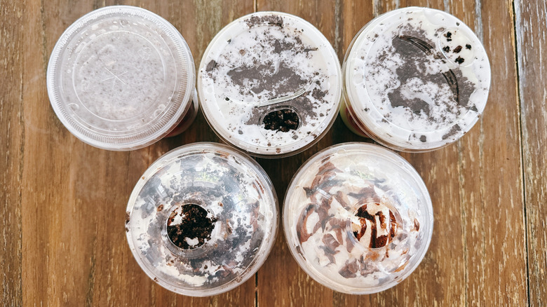 Top view of five Dunkin' Oreo drinks on a wooden table