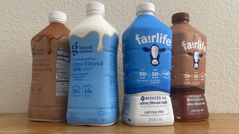 Four milk bottles arranged in a loose triangle