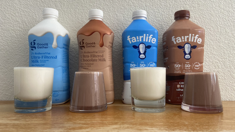 view from below of each milk bottle with a full glass in front of it