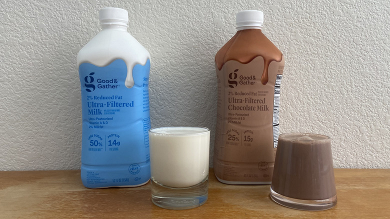 Target ultra-filtered milk and chocolate milk bottles with a glass of each poured out
