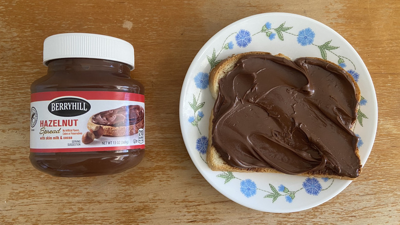 Aldi jar beside Berryhill spread on a piece of bread