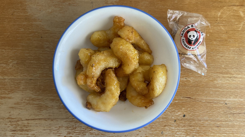 top-down view of the Panda Express shrimp beside a fortune cookie