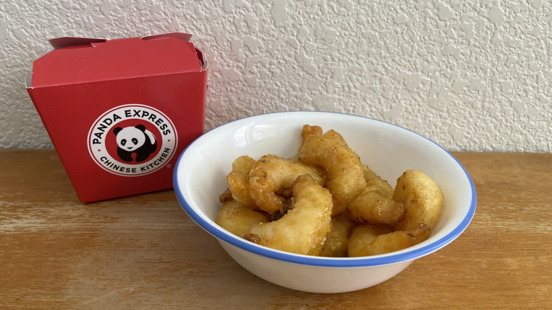 bowl of Panda Express shrimp beside its container