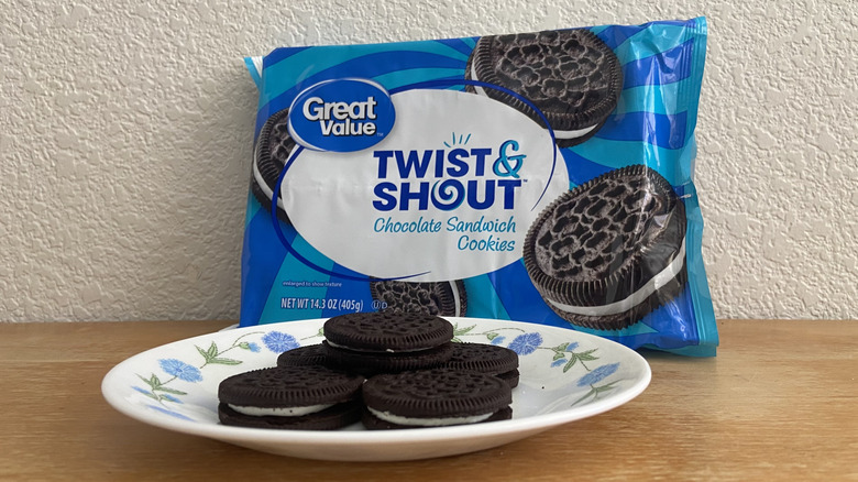 a pile of Twist & Shout cookies on a small plate in front of their packaging