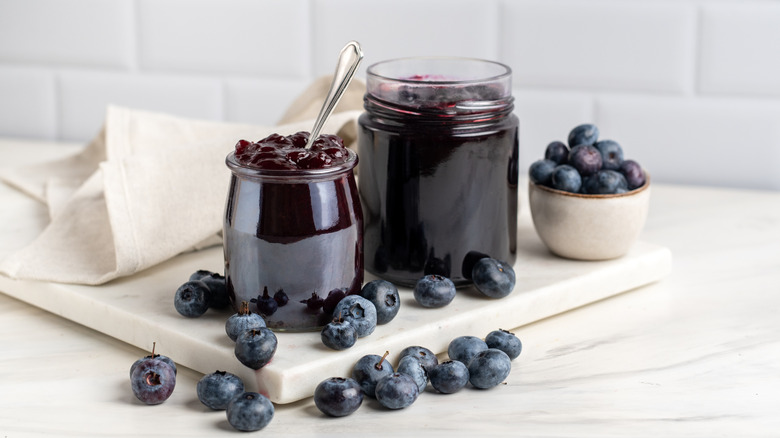 blueberry jam next to fresh blueberries