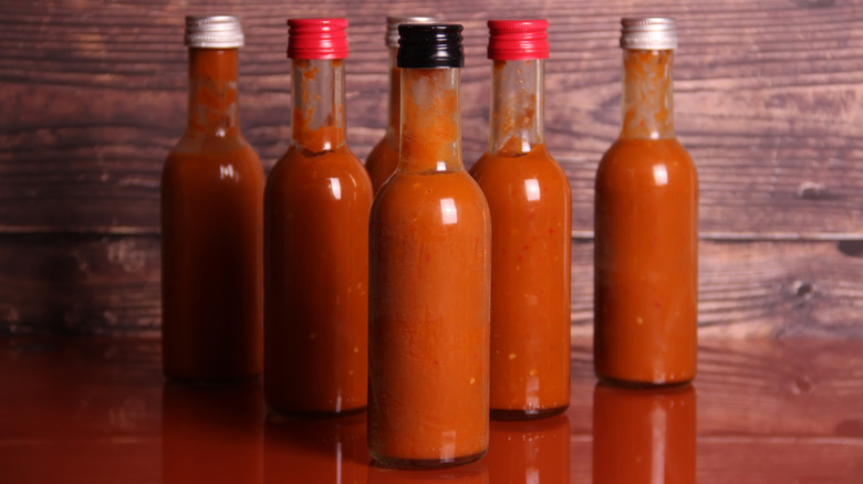 Assorted glass bottles of hot sauce