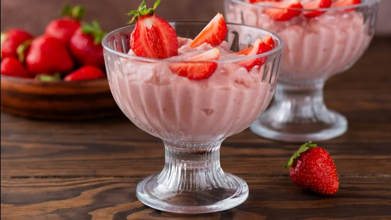 A glass dessert cup filled with fluffy Jell-O recipe and strawberries