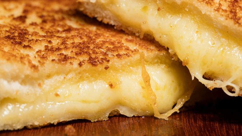 Closeup of cross section of very filled grilled cheese sandwich.